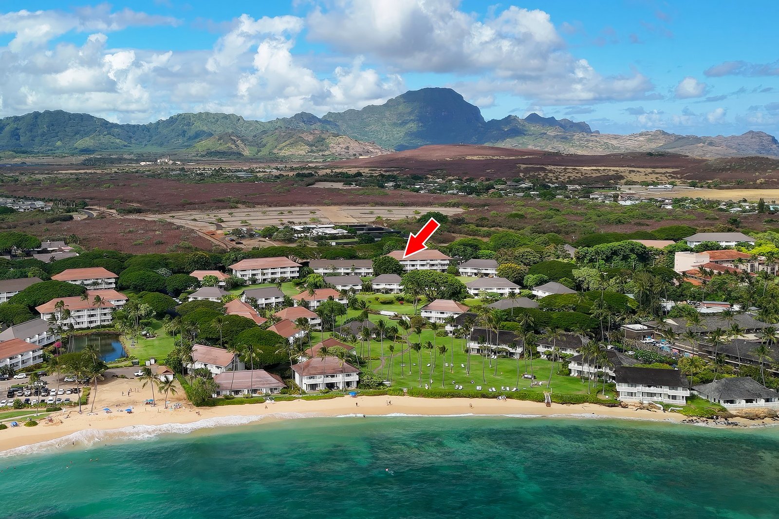 Aerial view of Kiahuna Plantation with Poipu Beach and the mountains beyond